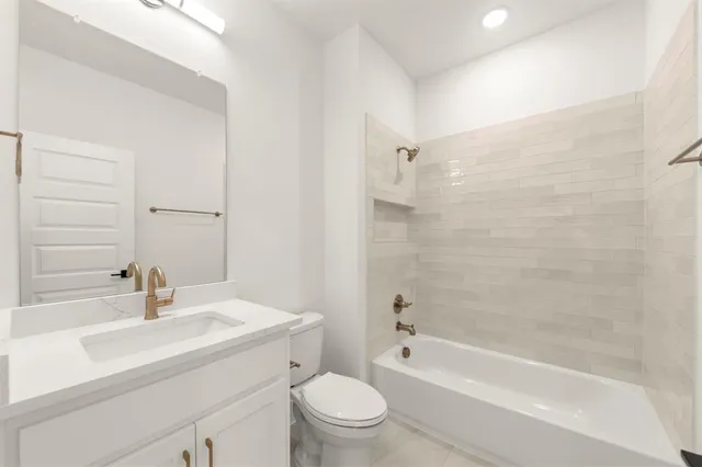 a bathroom with a sink a toilet and a bathtub