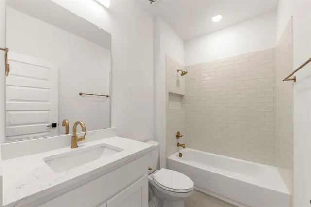 a bathroom with a sink a toilet and a bathtub