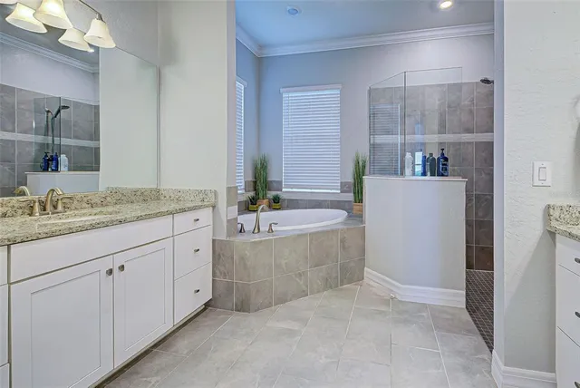 a bathroom with a granite countertop bathtub sink and mirror