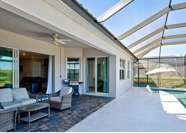 a view of living room filled with furniture and a chandelier