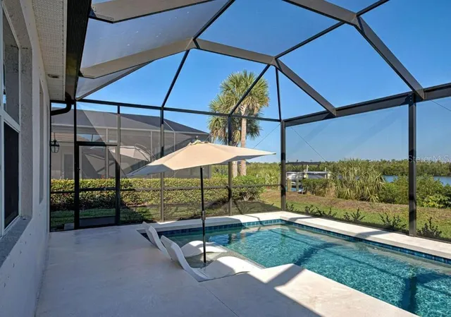 a view of backyard with a table and chairs