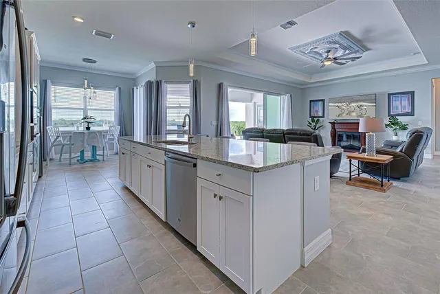a large kitchen with kitchen island granite countertop a large counter top and sink