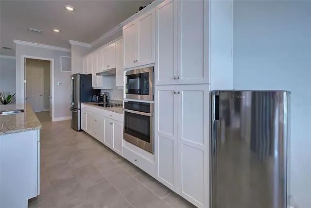 a kitchen with cabinets stainless steel appliances and a counter top