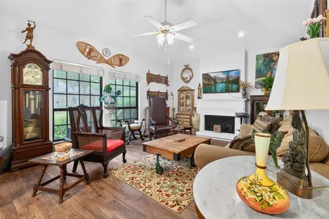 a living room with furniture a fireplace and a table