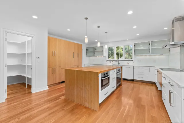 a kitchen with a sink and wooden floor