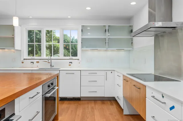 a kitchen with granite countertop white cabinets and a sink