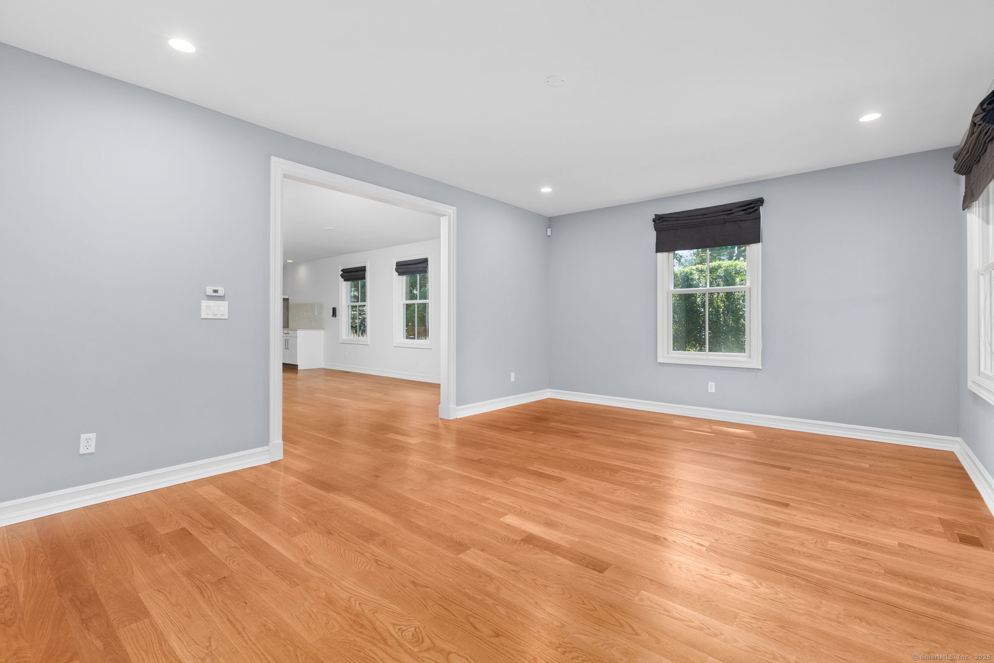 84 Olmstead Lane Ridgefield, CT 06877 - Photo 19 of 39 an empty room with wooden floor and windows