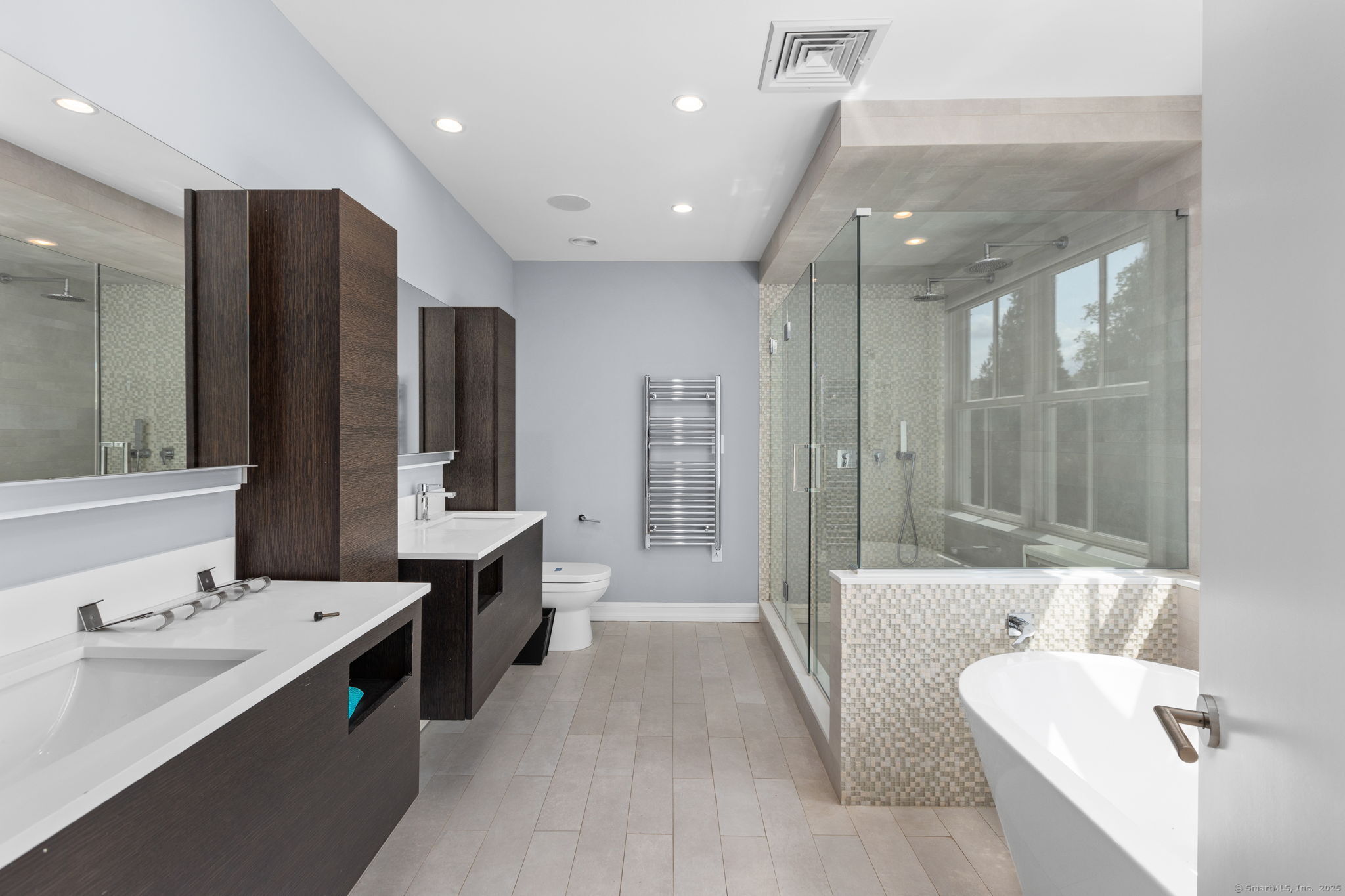 84 Olmstead Lane Ridgefield, CT 06877 - Photo 24 of 39 a large spacious bathroom with a double vanity sink a large mirror and a bathtub