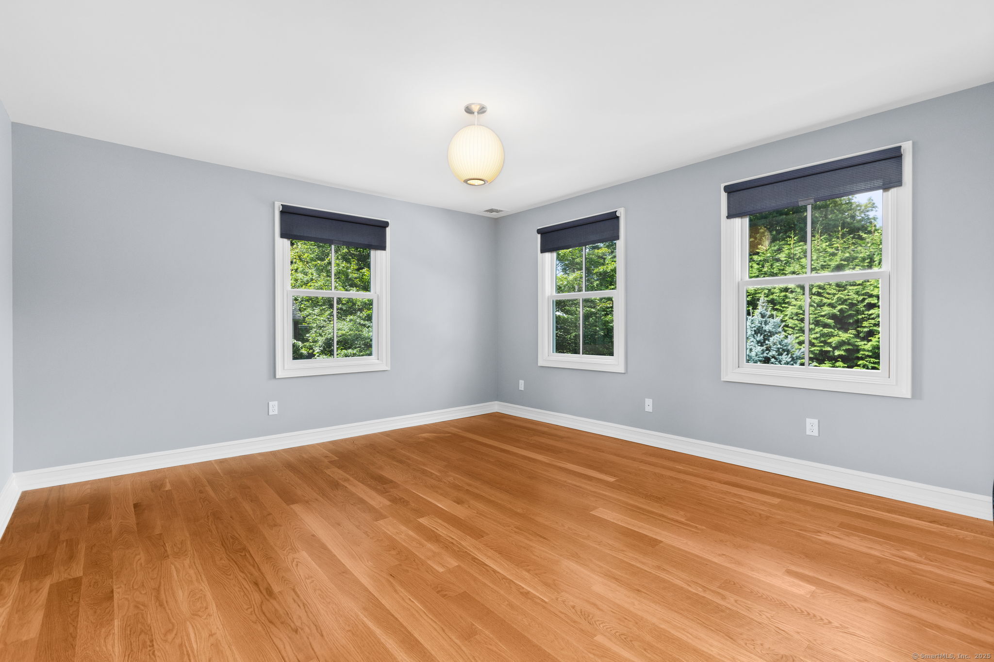 84 Olmstead Lane Ridgefield, CT 06877 - Photo 25 of 39 a view of an empty room with wooden floor and a window
