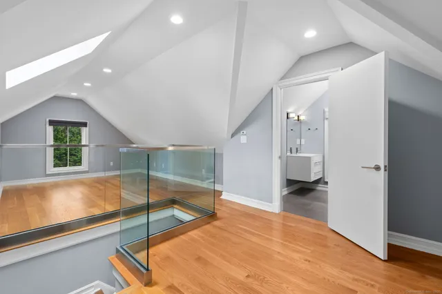 a view of an empty room with wooden floor and closet