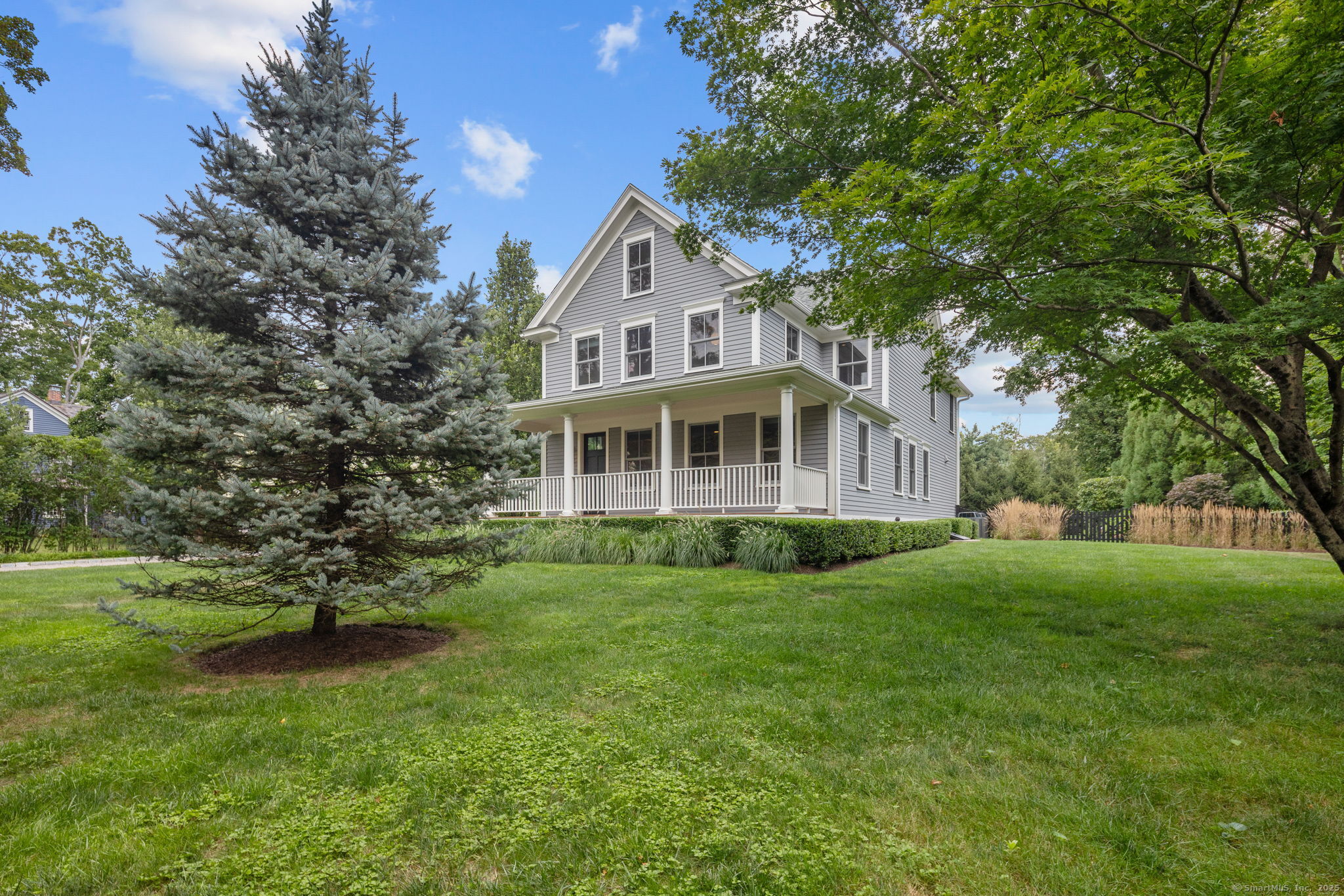 84 Olmstead Lane Ridgefield, CT 06877 - Photo 3 of 39 a front view of a house with a garden