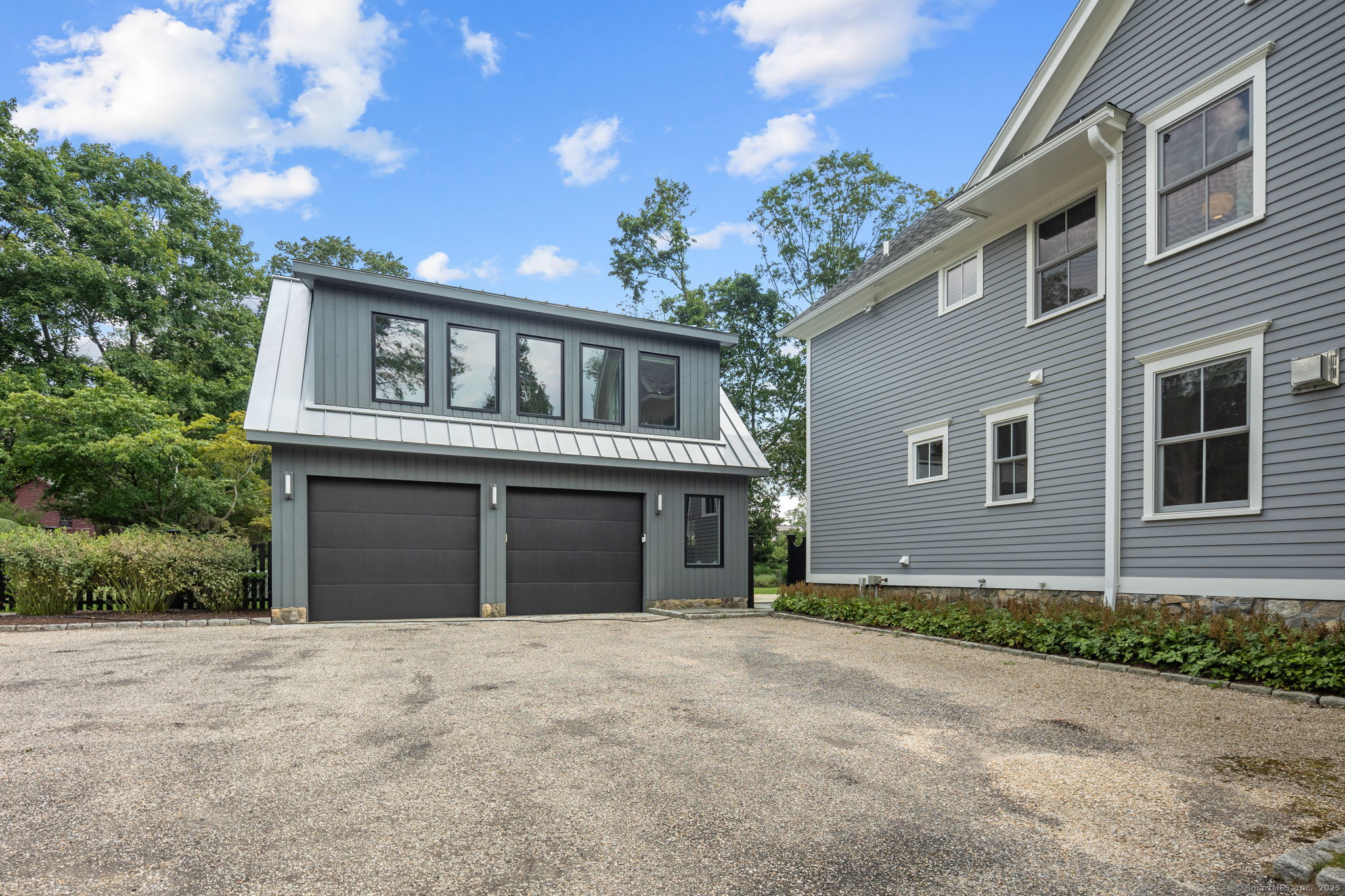 84 Olmstead Lane Ridgefield, CT 06877 - Photo 36 of 39 a front view of a house with a garden