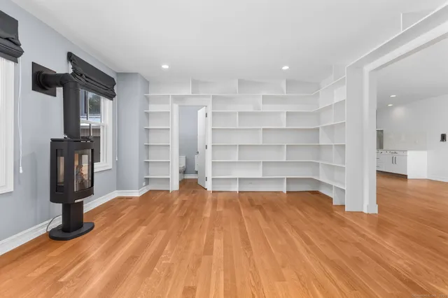a room with a wooden floor and a book shelf