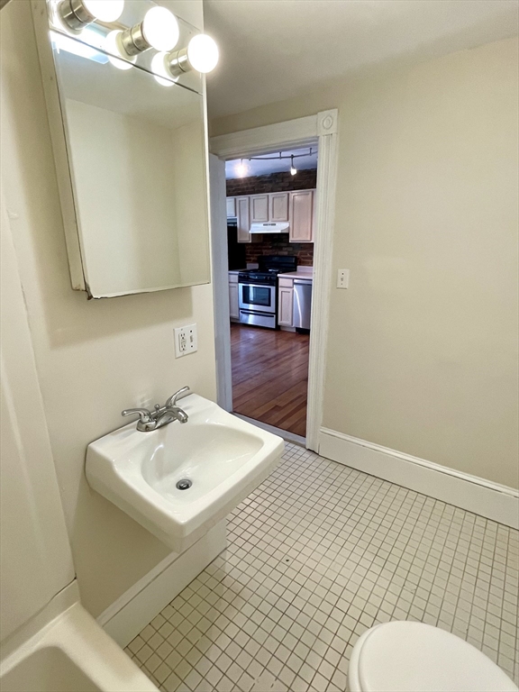 6 Mead Street, Unit 2 Boston, MA 02134 - Photo 4 of 8 a bathroom with a sink a toilet and mirror