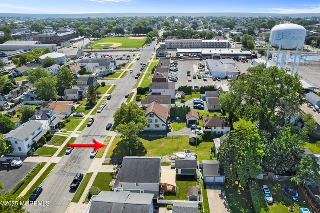 an aerial view of residential houses with outdoor space and parking
