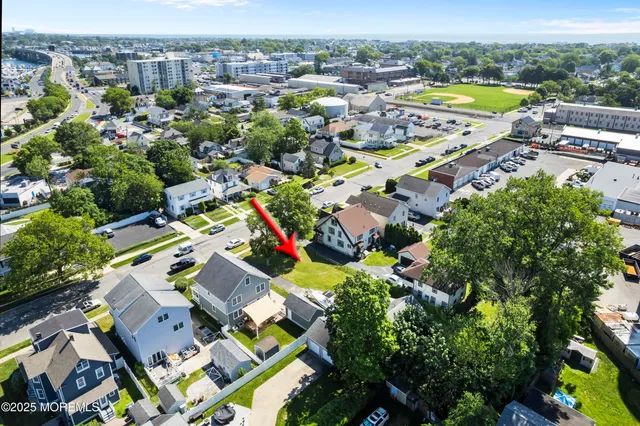 an aerial view of residential houses with outdoor space and swimming pool