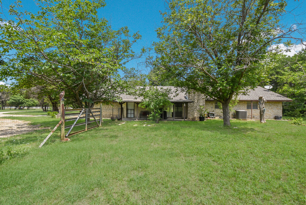 301 Navajo Trail Georgetown, TX 78633 - Photo 12 of 35 View of property hidden behind natural elements featuring central AC