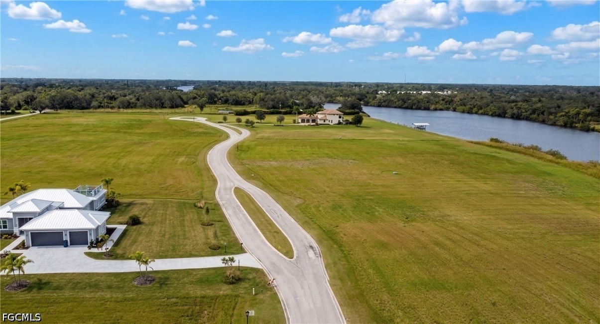 22820 Yellow Button Lane Alva, FL 33920 - Photo 5 of 6 a view of a swimming pool with an ocean view