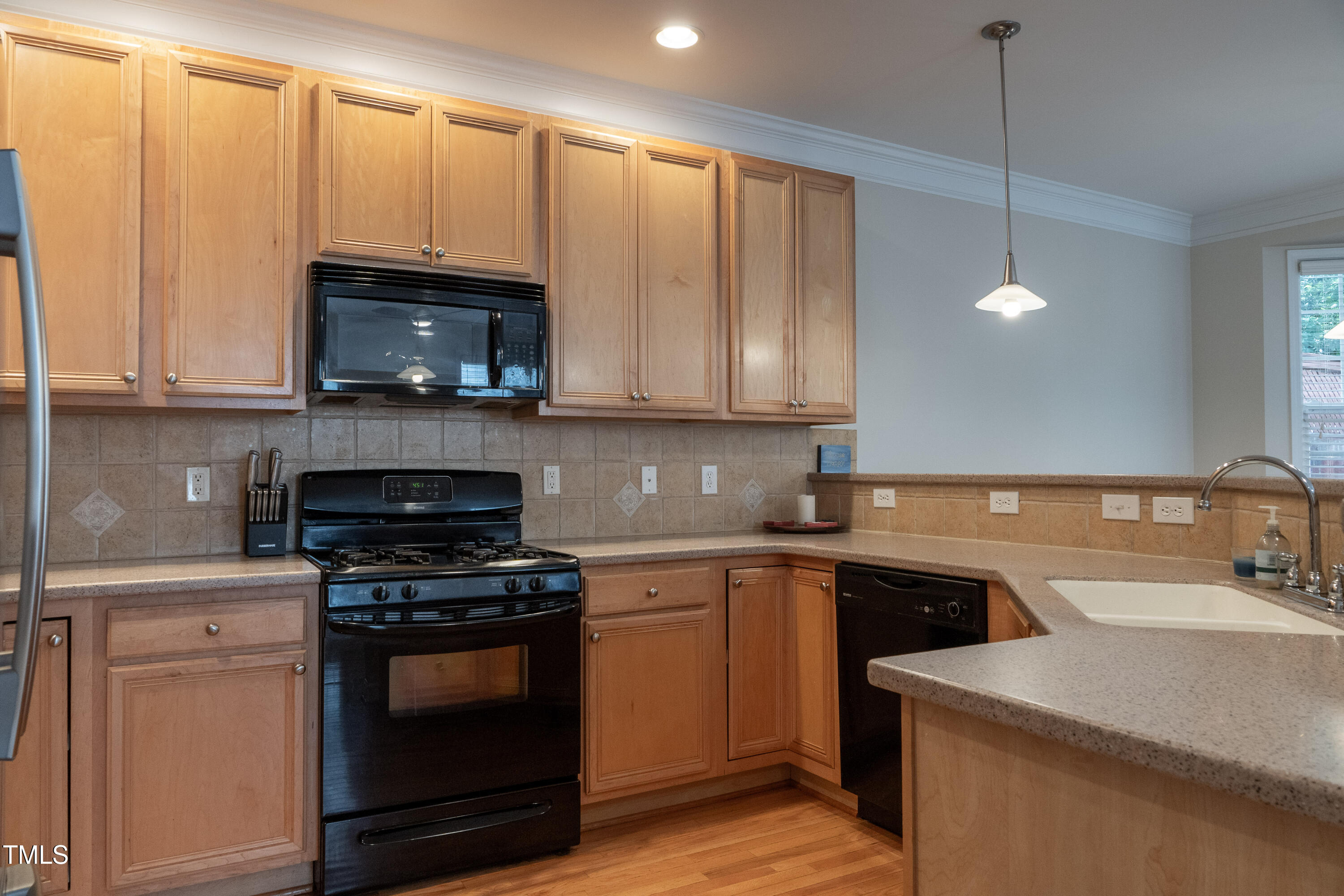5944 Kohler Lane Raleigh, NC 27616 - Photo 10 of 26 a kitchen with a sink a stove and microwave