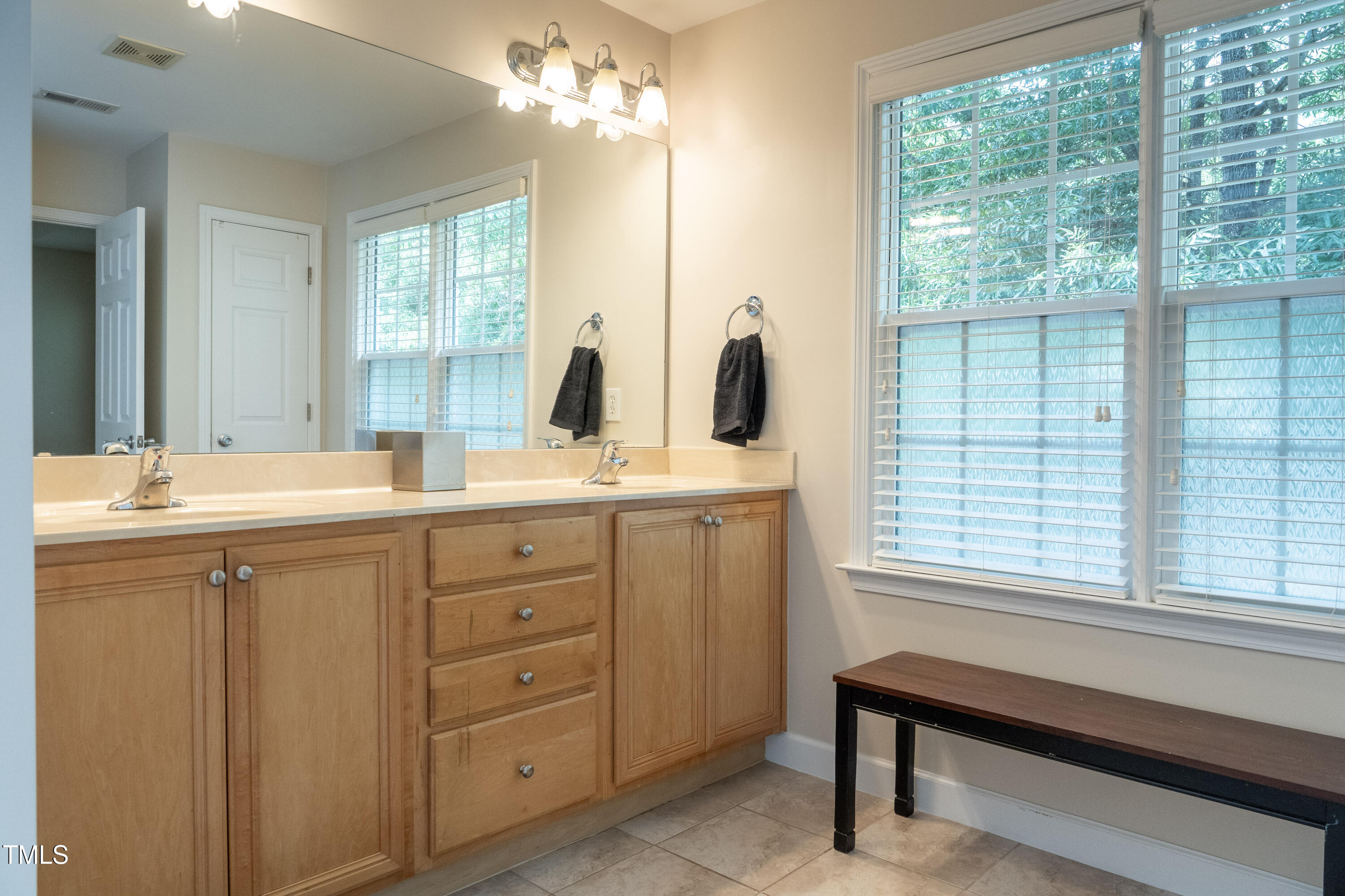 5944 Kohler Lane Raleigh, NC 27616 - Photo 15 of 26 a bathroom with double vanity and a mirror