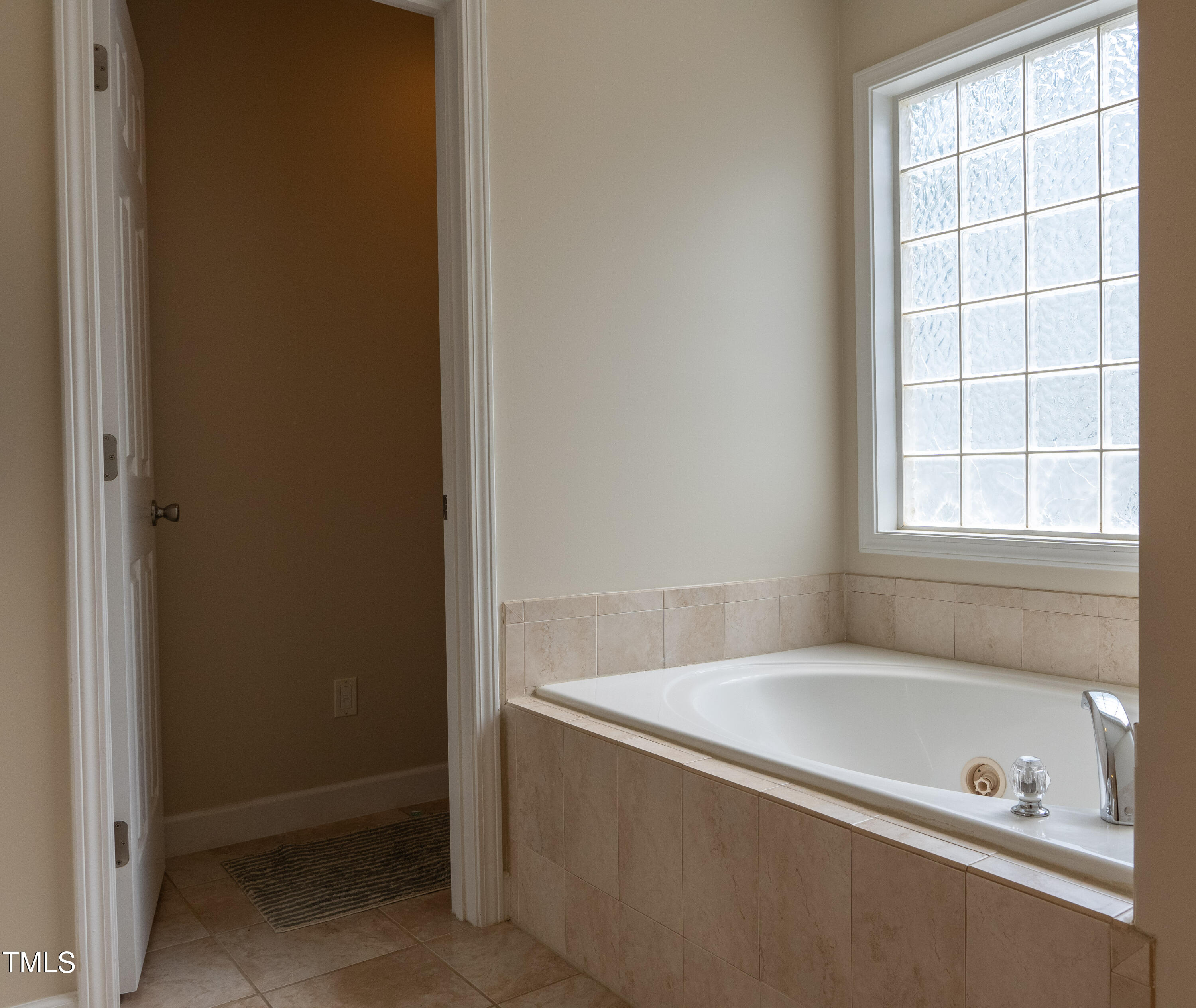 5944 Kohler Lane Raleigh, NC 27616 - Photo 17 of 26 a bathroom with a tub and a window