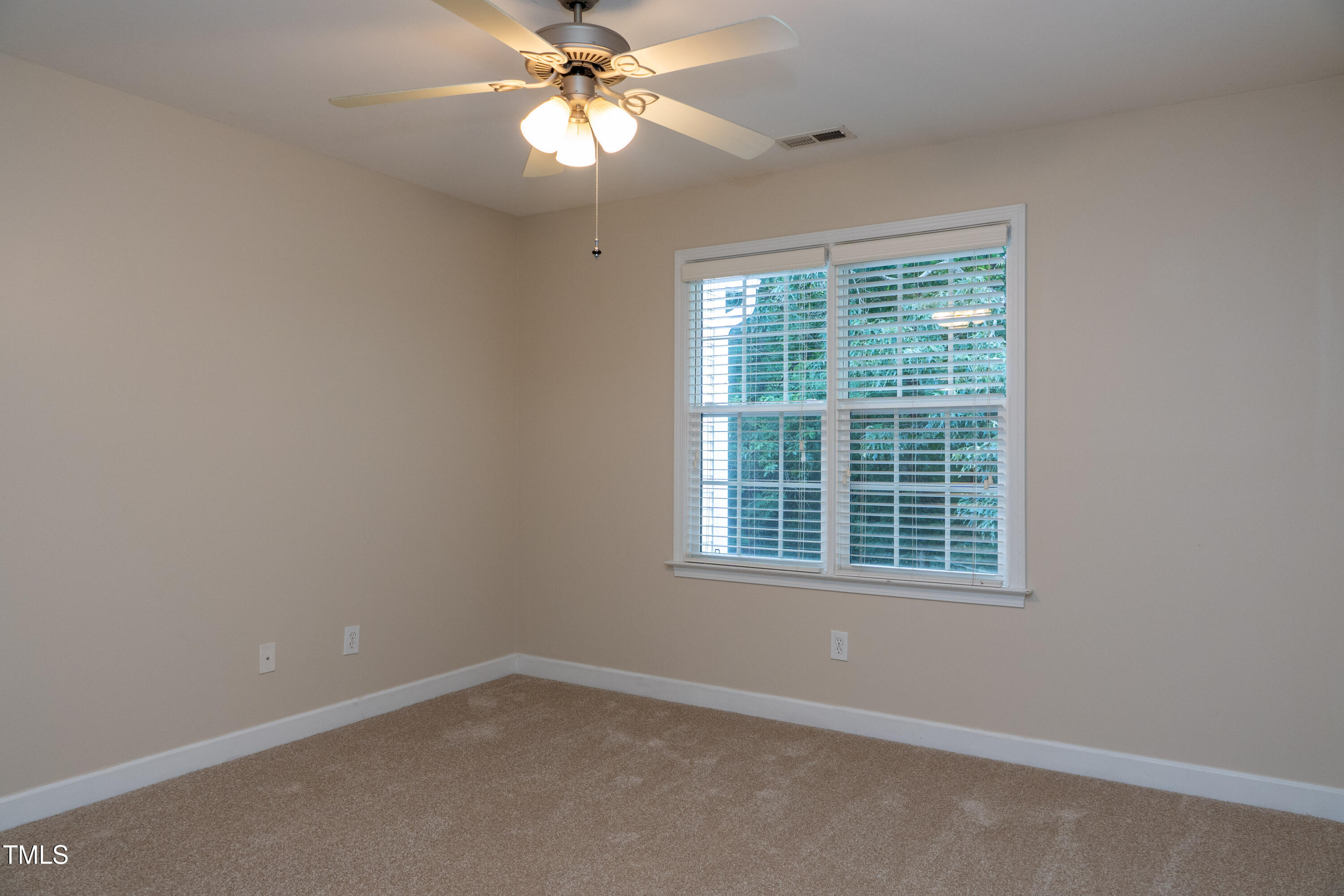 5944 Kohler Lane Raleigh, NC 27616 - Photo 21 of 26 an empty room with a window and a fan