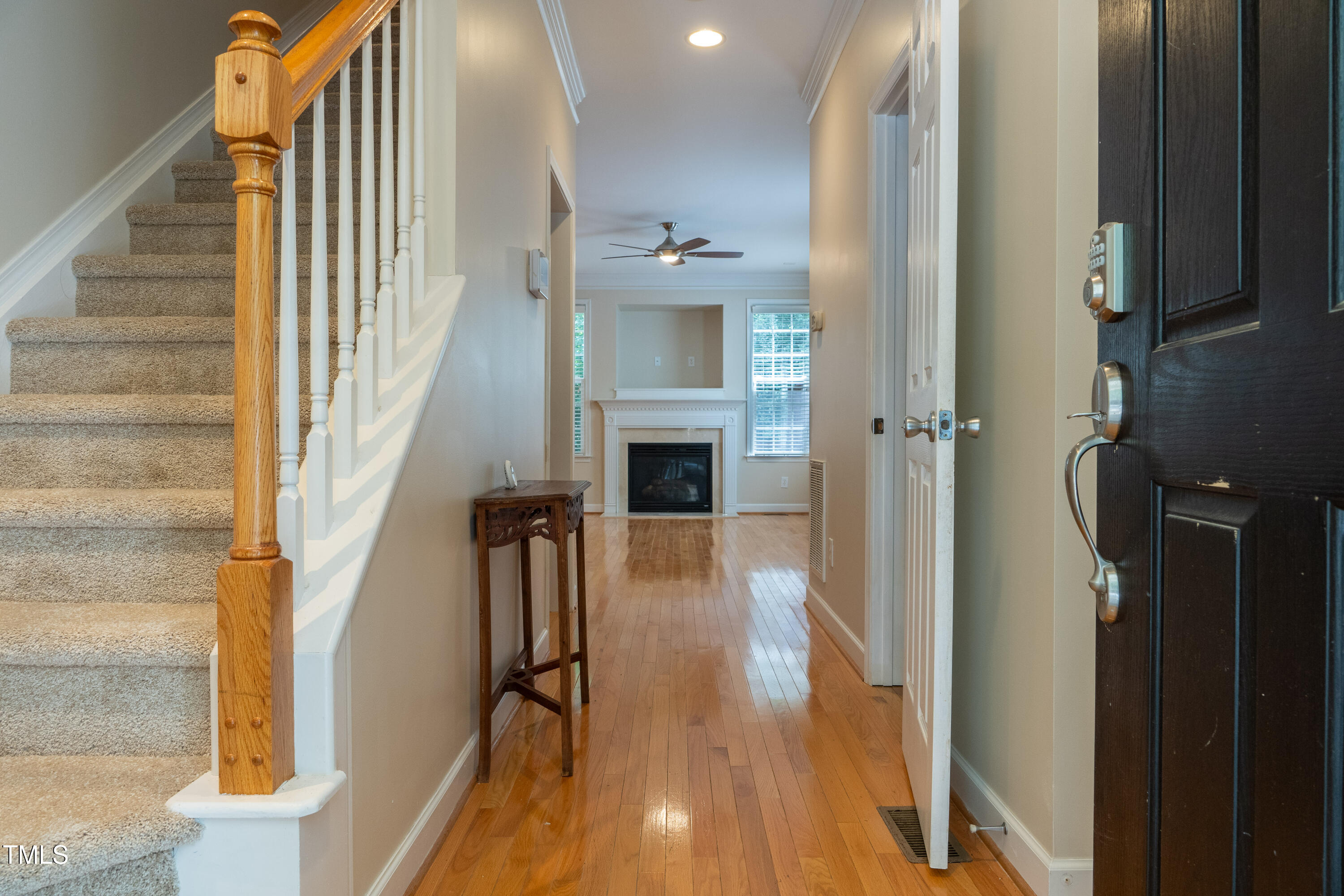 5944 Kohler Lane Raleigh, NC 27616 - Photo 5 of 26 a view of a hallway with wooden floor and staircase