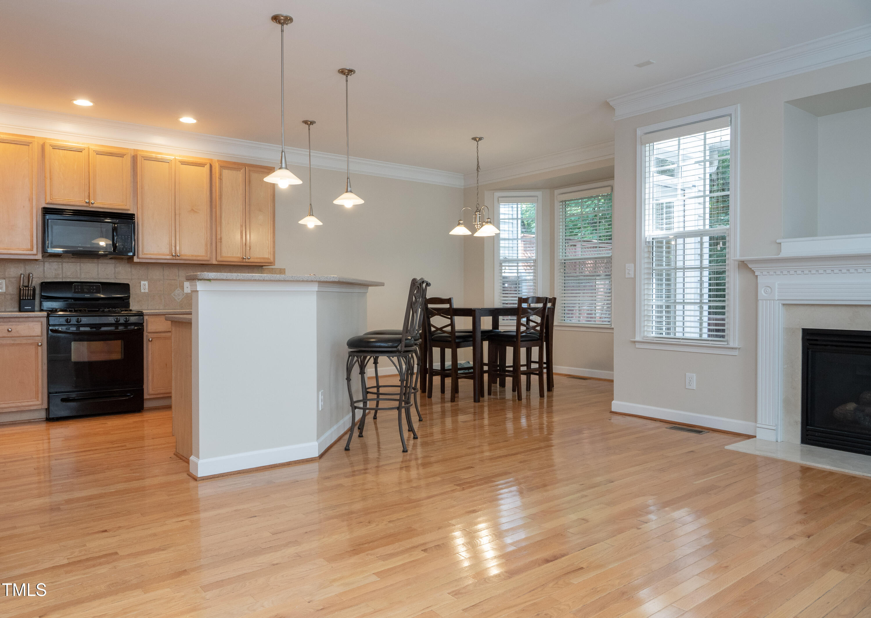 5944 Kohler Lane Raleigh, NC 27616 - Photo 7 of 26 a view of a kitchen with dining table chairs and flat screen tv