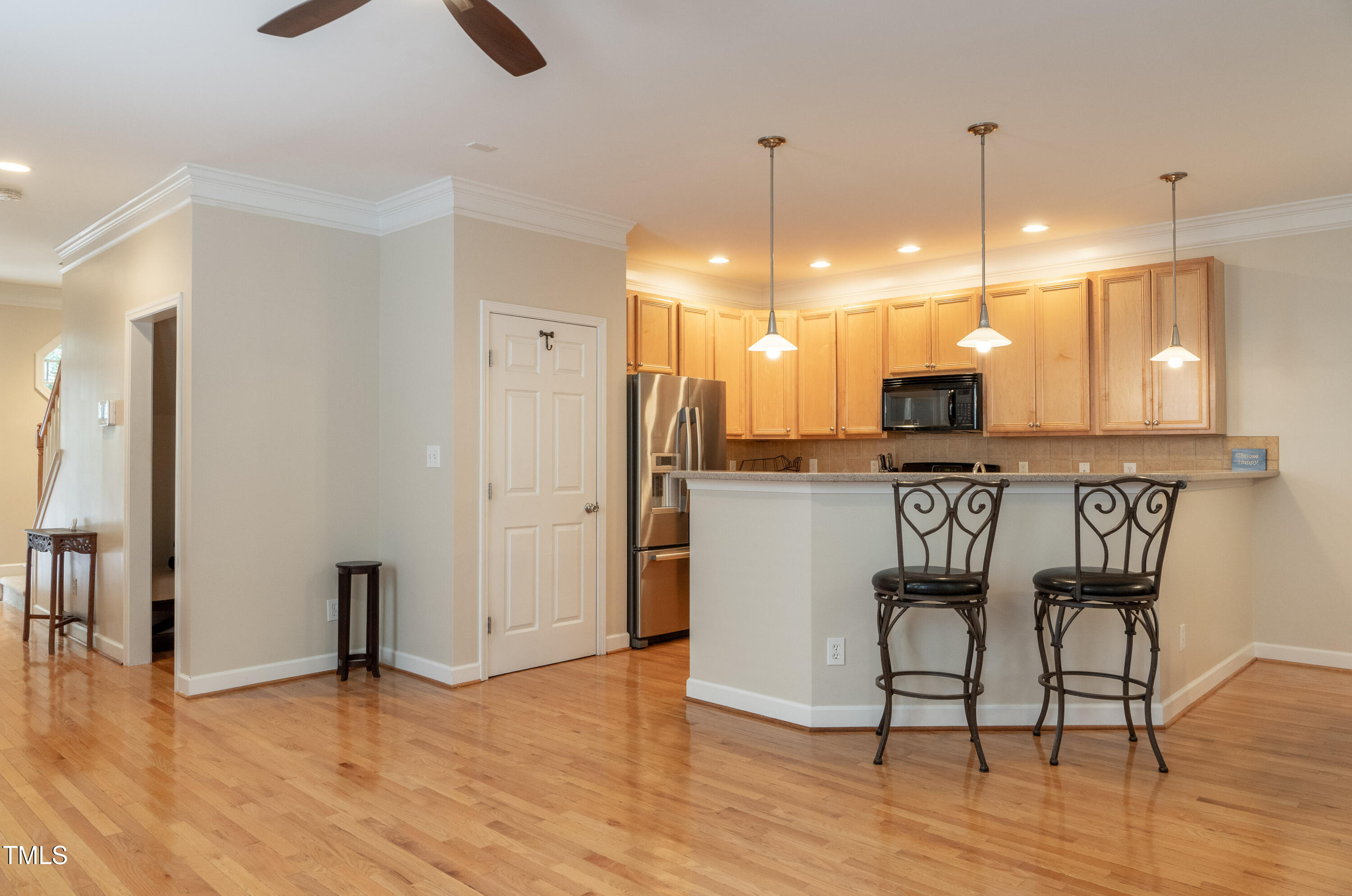 5944 Kohler Lane Raleigh, NC 27616 - Photo 9 of 26 a view of a kitchen with stainless steel appliances granite countertop a refrigerator a stove a sink dishwasher with a dining table and chairs