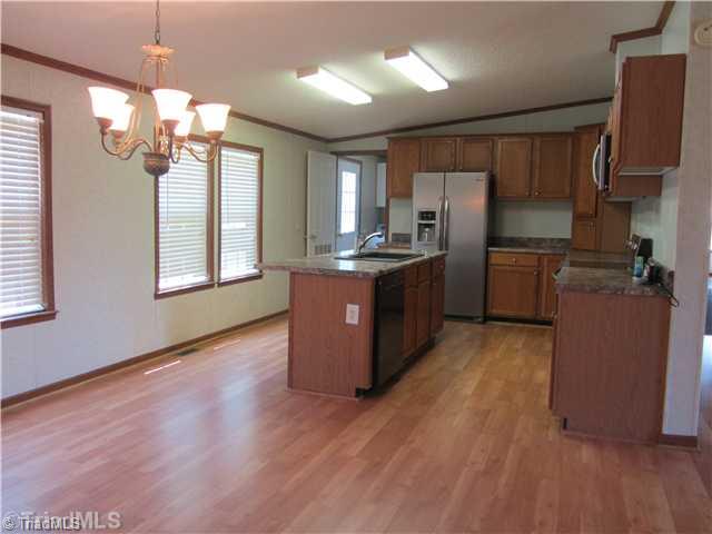 1901 Martin Farm Road Madison, NC 27025 - Photo 6 of 16 Kitchen. New Laminate floors and new appliances