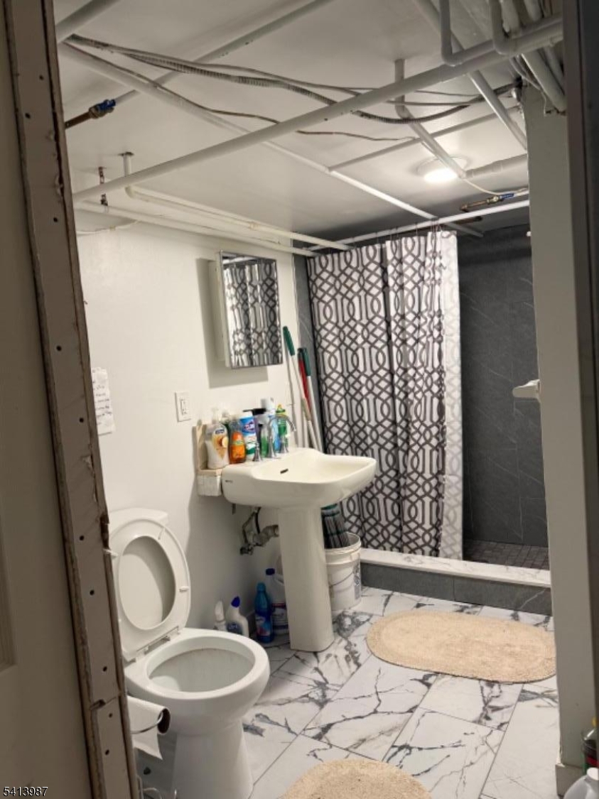 5 Dewey Street Dover, NJ 07801 - Photo 11 of 18 a bathroom with a sink toilet and shower