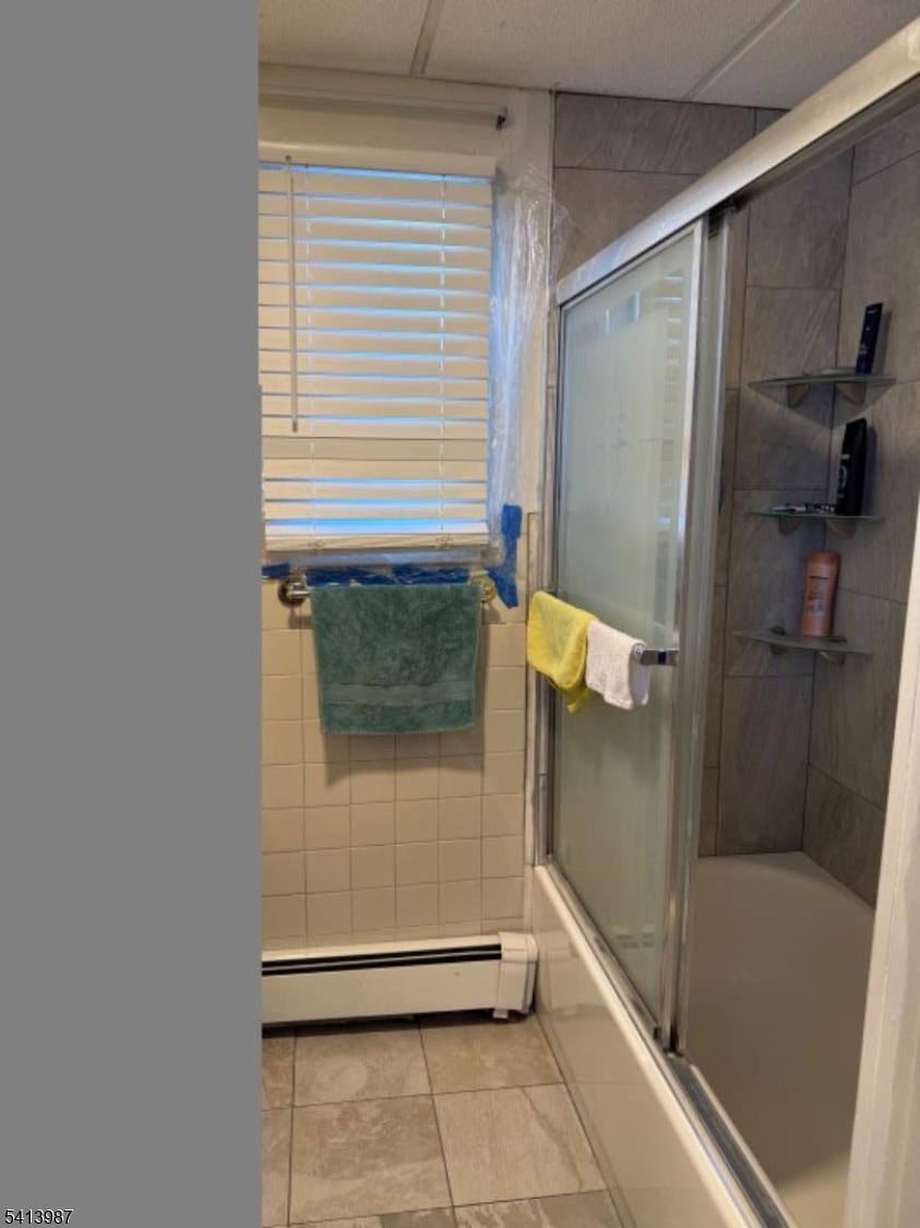 5 Dewey Street Dover, NJ 07801 - Photo 12 of 18 a bathroom with a bathtub and a shower