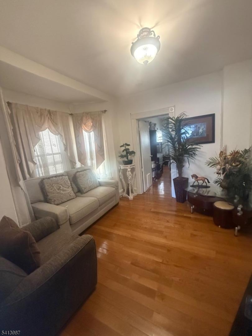 5 Dewey Street Dover, NJ 07801 - Photo 5 of 18 a living room with furniture and a chandelier