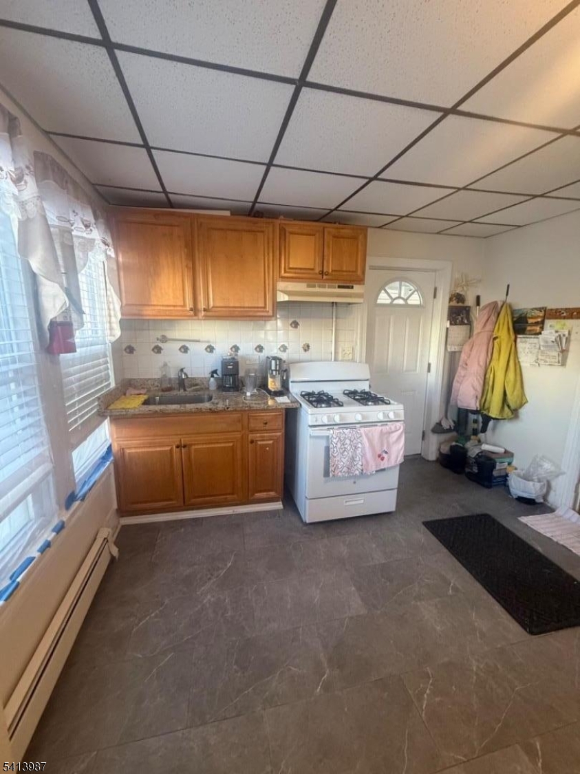 5 Dewey Street Dover, NJ 07801 - Photo 7 of 18 a kitchen with stainless steel appliances a sink a counter top space cabinets and a window