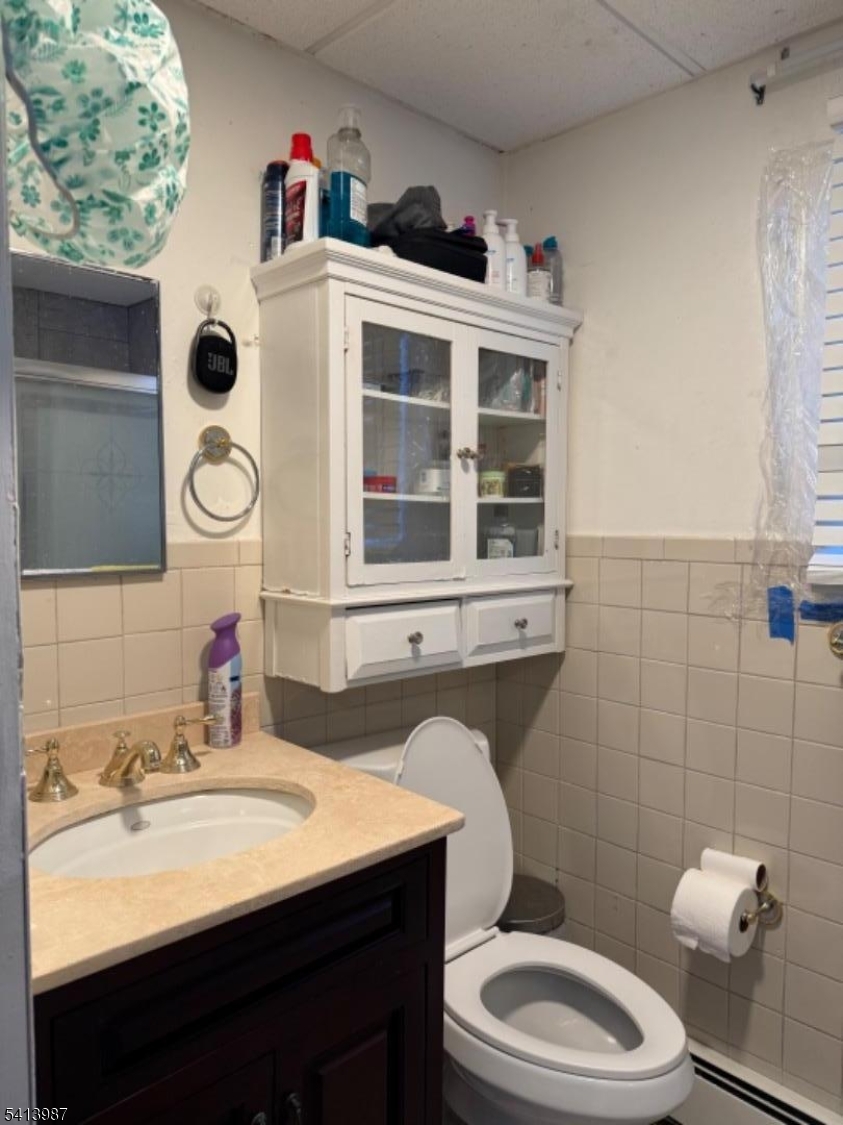 5 Dewey Street Dover, NJ 07801 - Photo 8 of 18 a bathroom with a sink a toilet and shower curtain