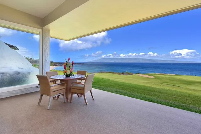 a living room with furniture a flat screen tv and a large window