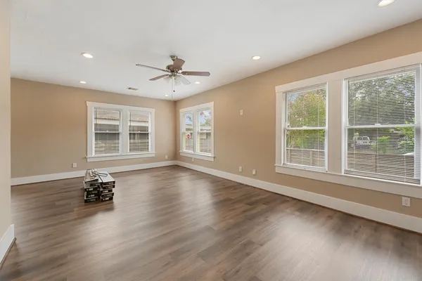 a view of wooden floor and windows in a room