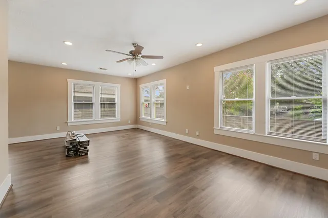a view of wooden floor and windows in a room