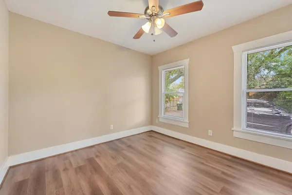 wooden floor in an empty room with a window