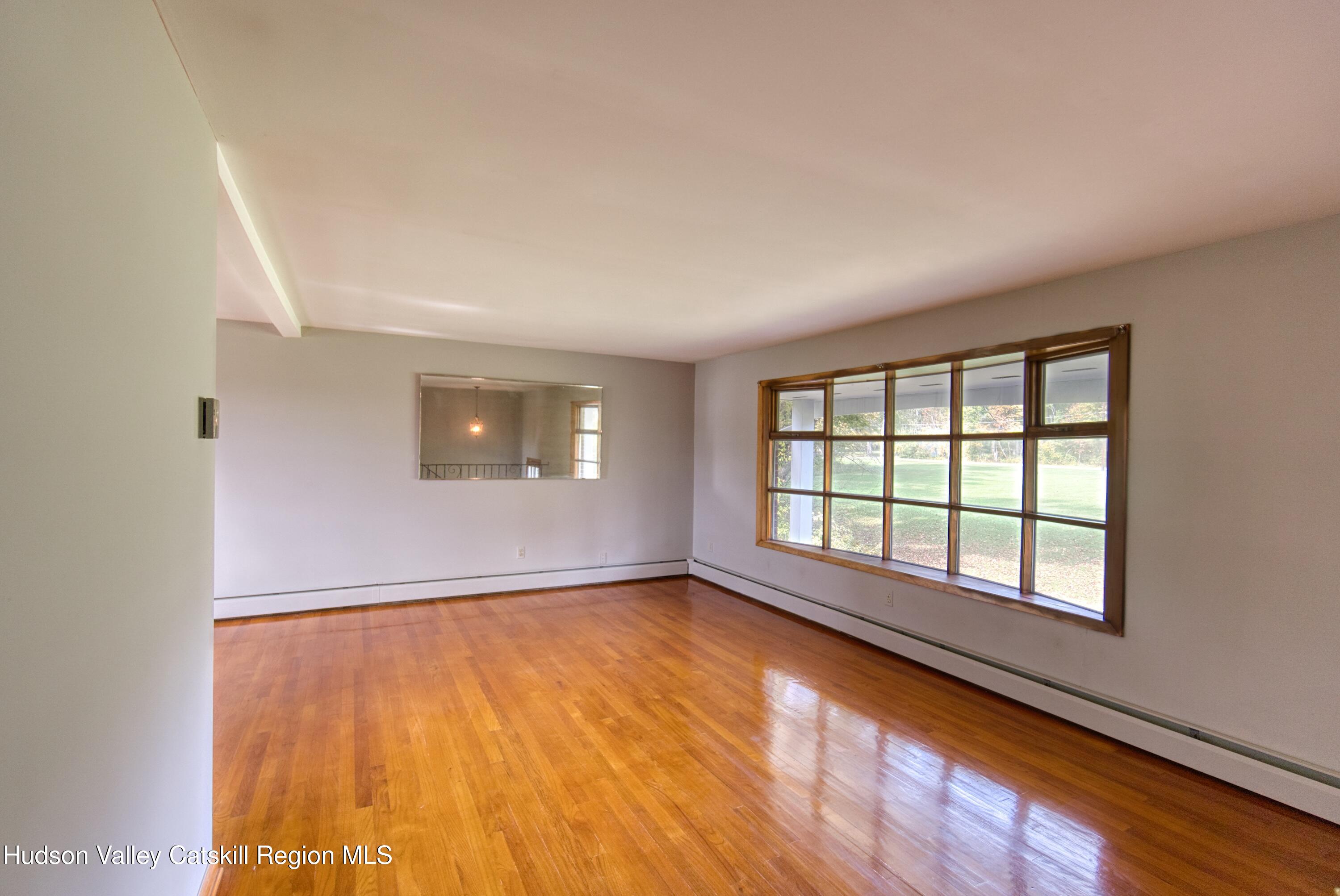 315 Pine Bush Road Stone Ridge, NY 12484 - Photo 16 of 30 an empty room with wooden floor and windows