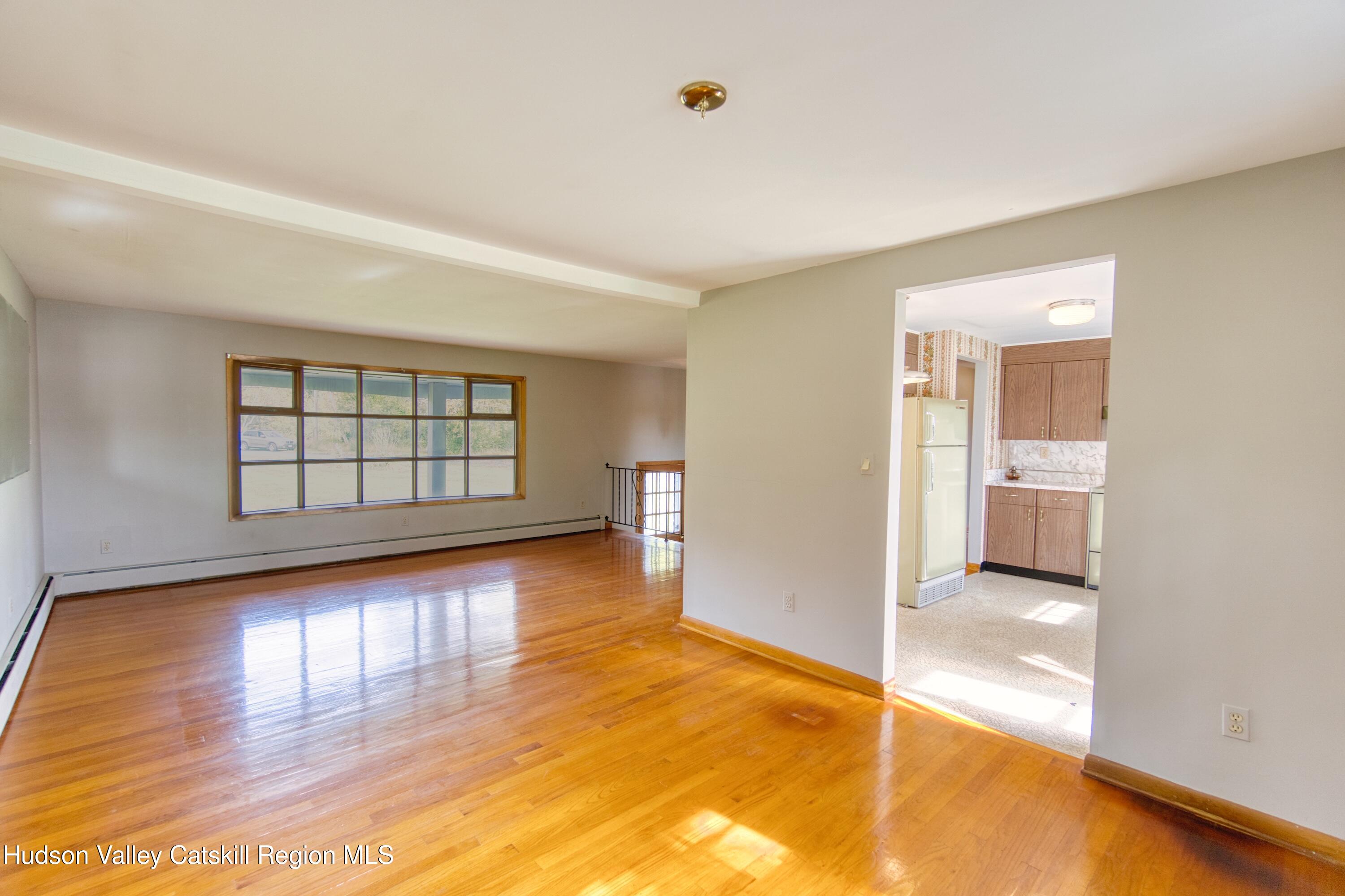 315 Pine Bush Road Stone Ridge, NY 12484 - Photo 17 of 30 wooden floor in an empty room with a window