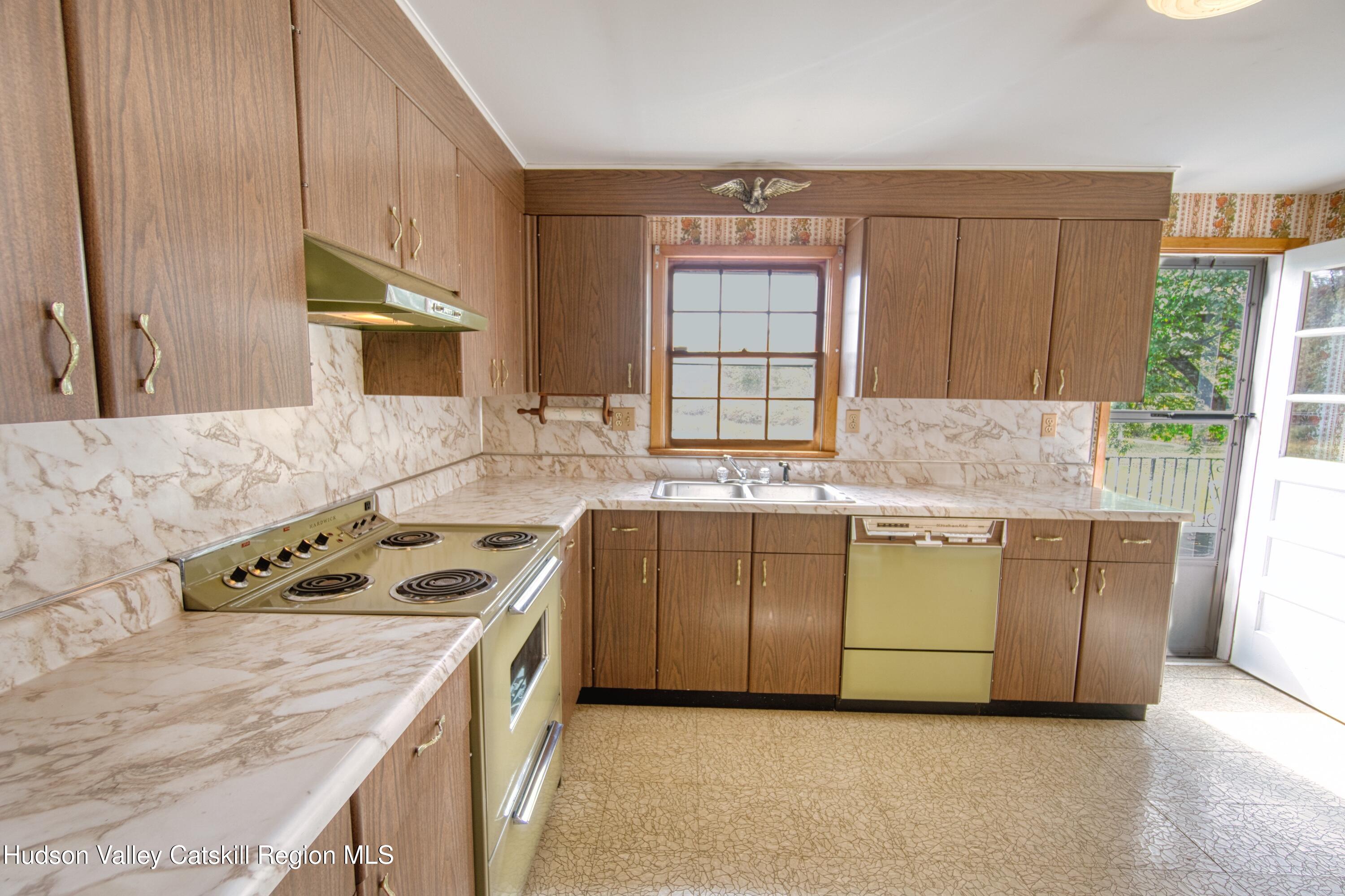 315 Pine Bush Road Stone Ridge, NY 12484 - Photo 19 of 30 a kitchen with granite countertop a sink stove and cabinets