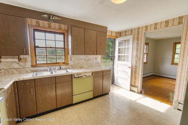 a view of a room with wooden floor and a window