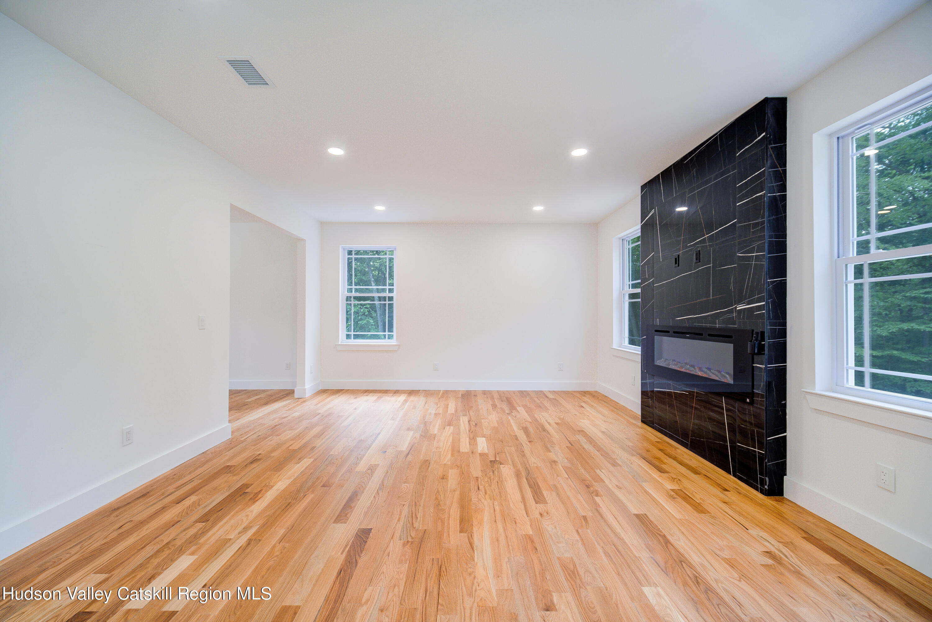 3 Calico Way, Unit WAYS Wallkill, NY 12589 - Photo 18 of 68 a view of an empty room with wooden floor and a window