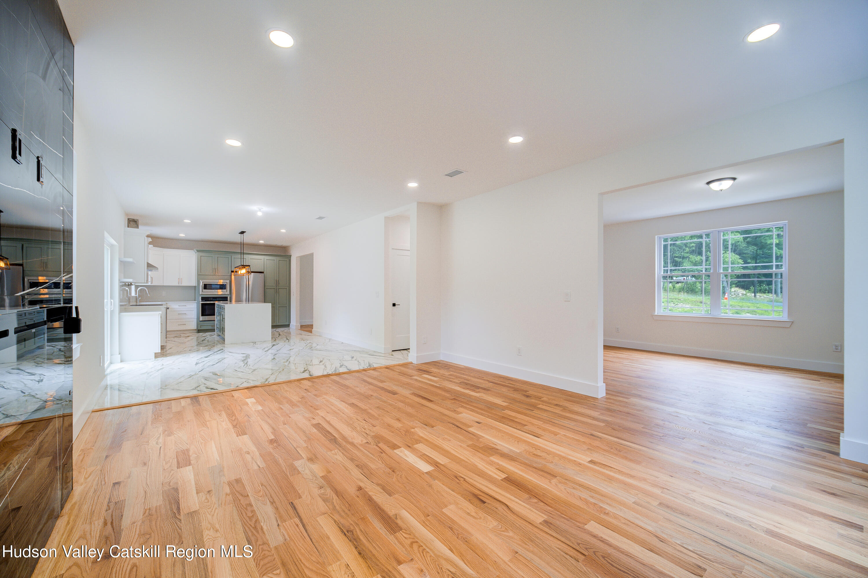3 Calico Way, Unit WAYS Wallkill, NY 12589 - Photo 21 of 68 a view of a big room with wooden floor and a window