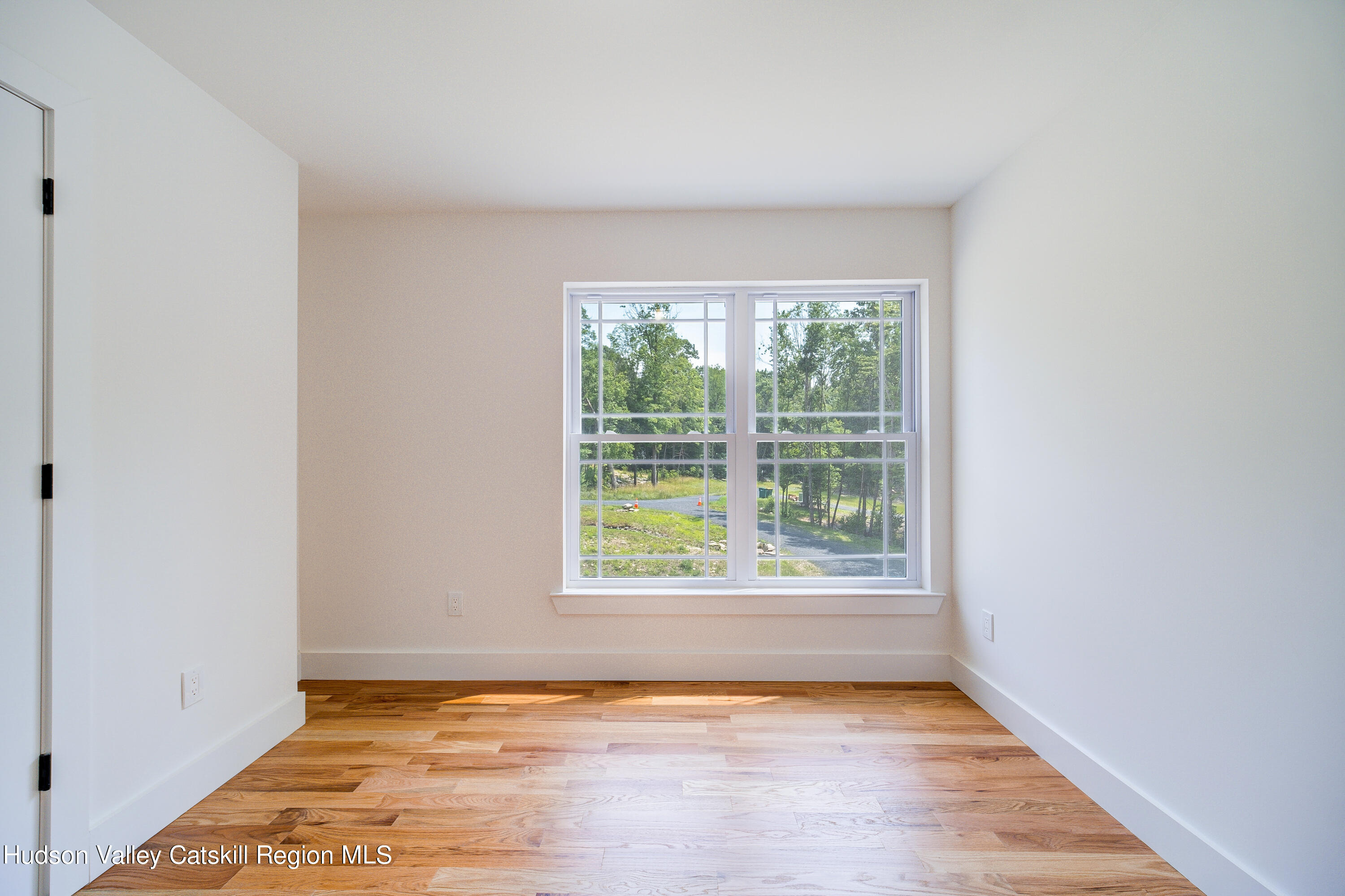 3 Calico Way, Unit WAYS Wallkill, NY 12589 - Photo 35 of 68 a view of an empty room with wooden floor and a window