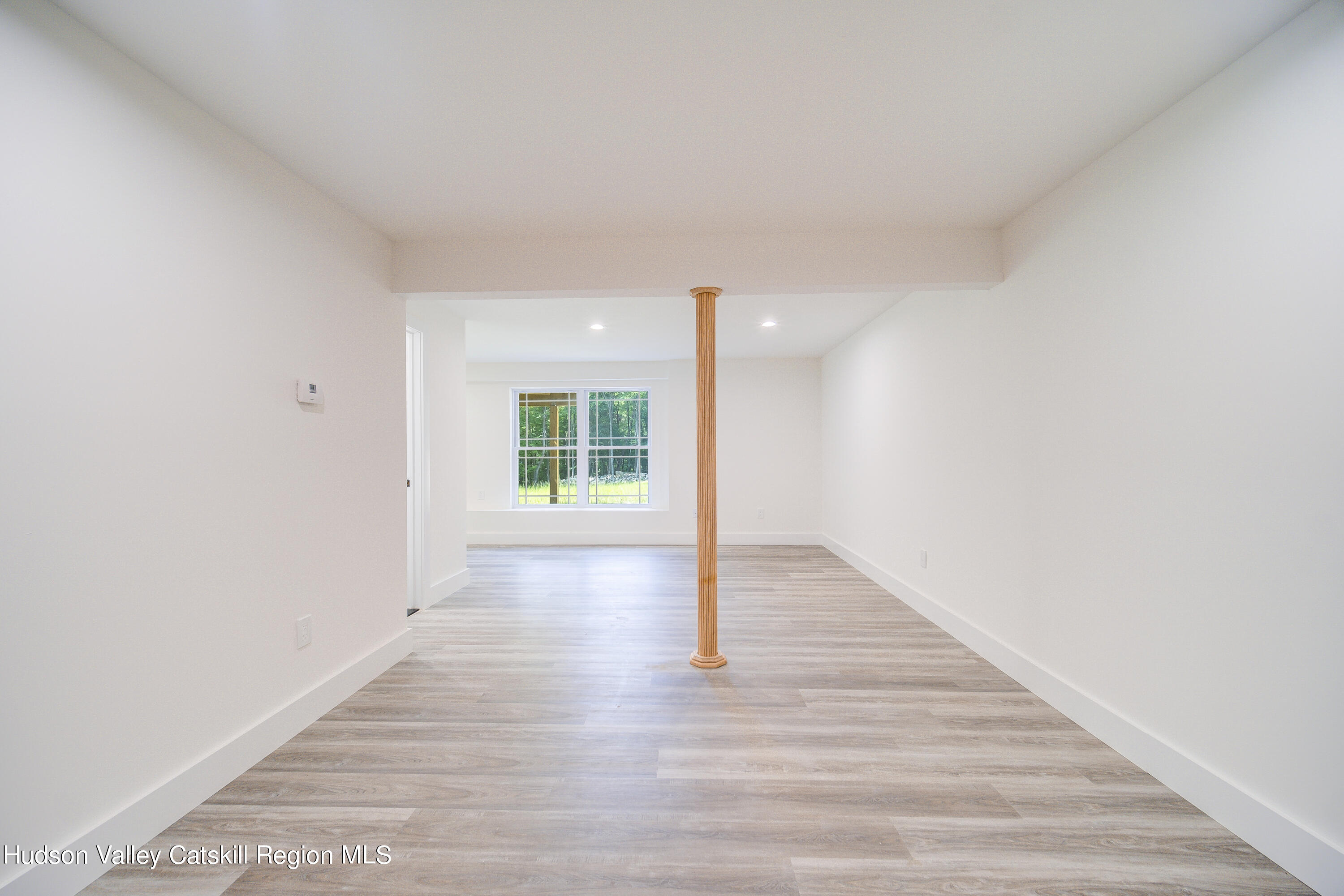 3 Calico Way, Unit WAYS Wallkill, NY 12589 - Photo 57 of 68 a view of an empty room with wooden floor and a window