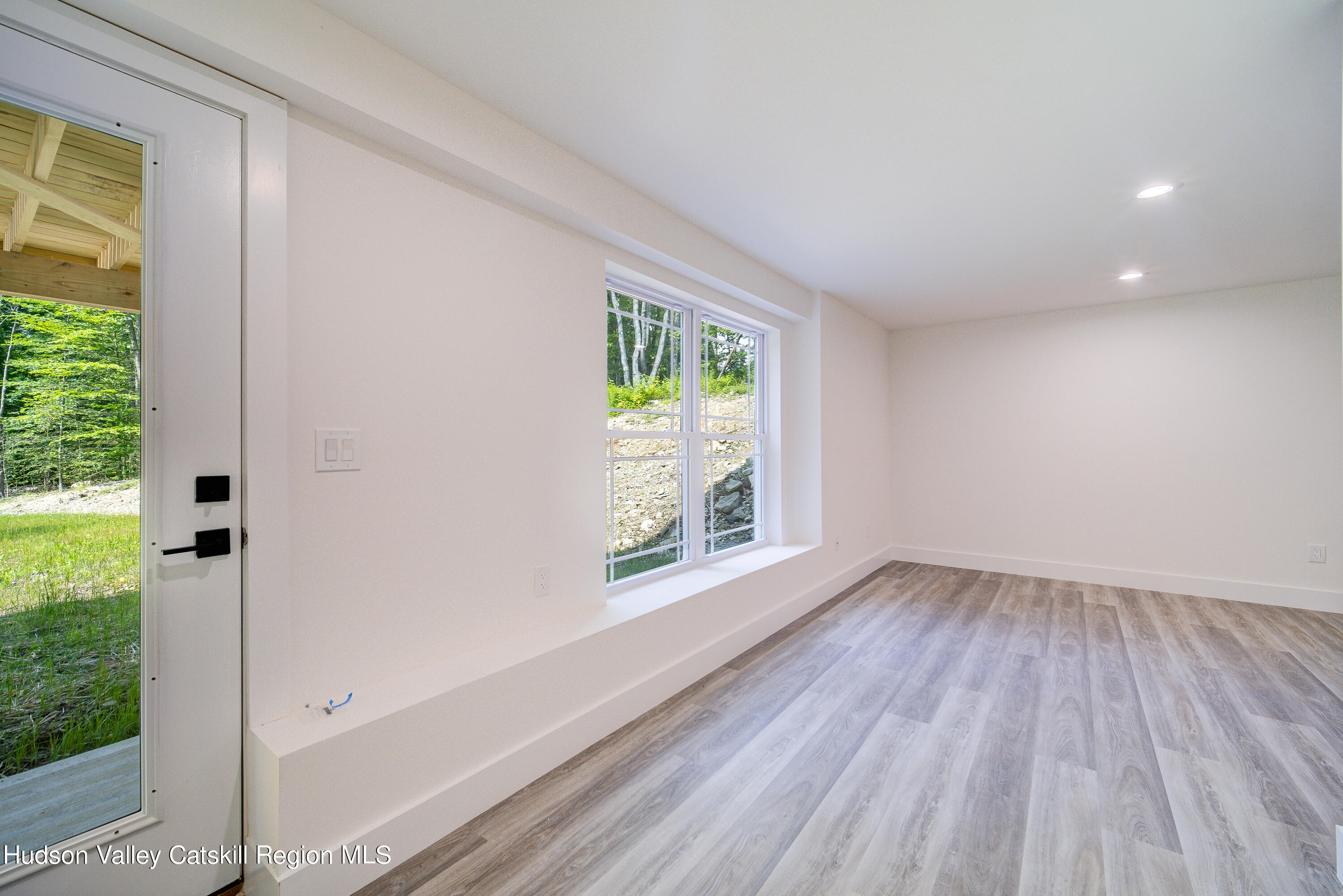 3 Calico Way, Unit WAYS Wallkill, NY 12589 - Photo 59 of 68 a view of an empty room with wooden floor and a window
