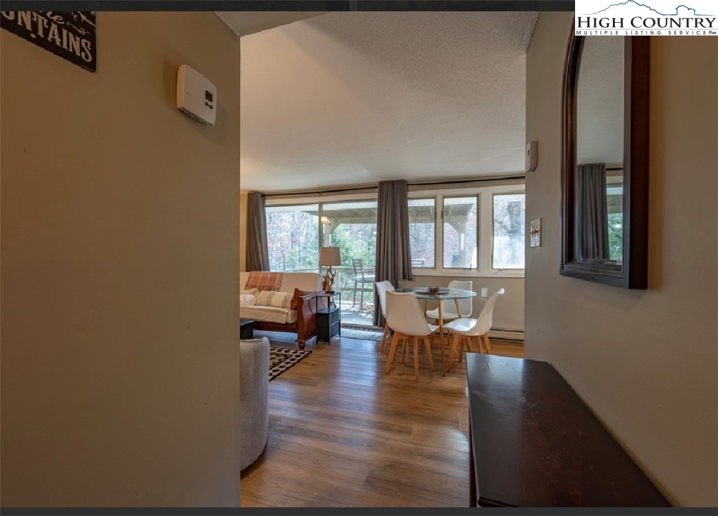 165 Briarcliff Road, Unit J42 Banner Elk, NC 28604 - Photo 15 of 20 a dining room with furniture and wooden floor
