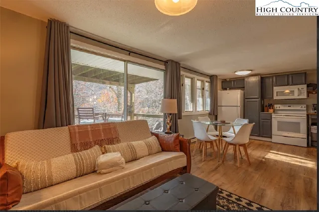 a living room with furniture and a large window